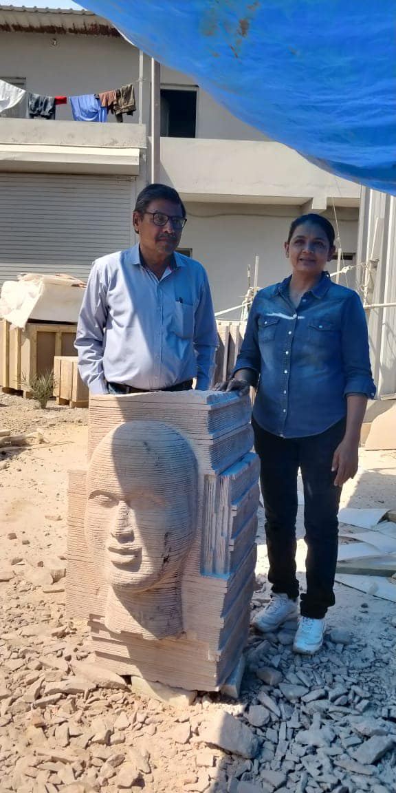 With a fellow artist beside the finished piece